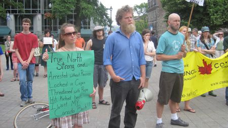 Protesters holding signs on Saturday at Grand Parade in Halifax
