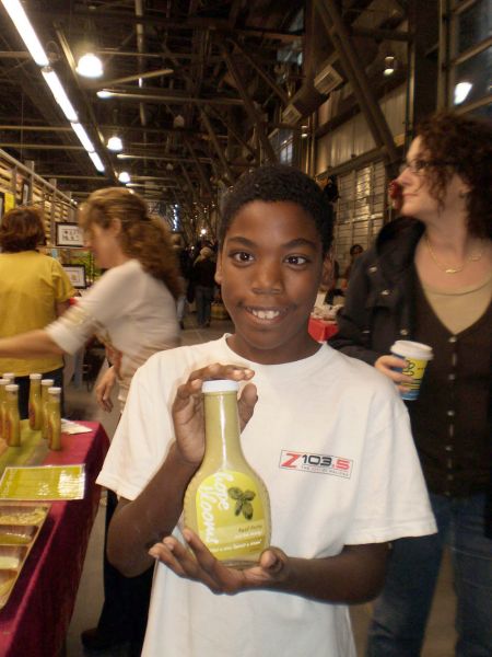 Craig Cain sells Hope Blooms salad dressing he helped make at the Halifax Farmers Market. The majority of the money from the business goes to a scholarship fund for the youth who volunteer their time. Photo: Charlene Davis