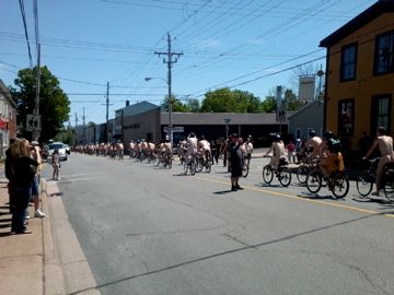 Nude cyclists setting off south on Agricola St.