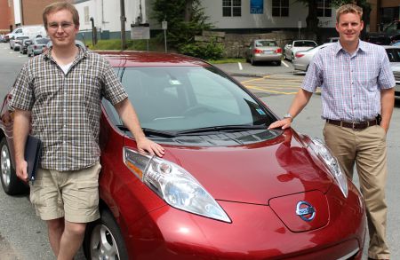 Post doctoral fellow of mechanical engineering Nathaniel Pearre (left) and professor of mechanical engineering Lukas Swan stand on either side of a fully electric Nissan Leaf in a Dalhousie University parking lot, just outside the Renewable Energy Storage Lab at which they both work.  Zack Metcalfe photo