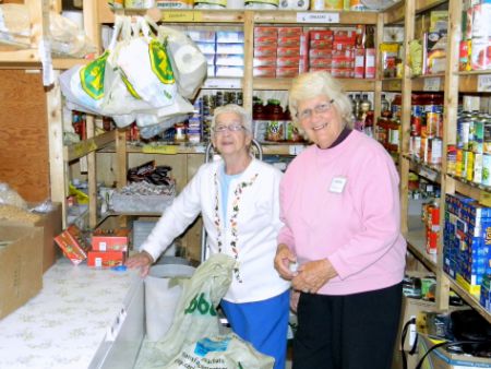 Helen and Heather prepare client orders in the pantry at Stairs United (Lamont Dobbin photo).