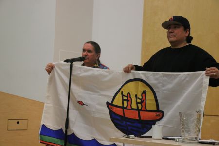 Ron Tremblay, former councillor for Tobique First Nation and member of Wolustuk Grand Council and Clayton Thomas Muller of Mathais Colomb Cree Nation in Treaty Six (Northern Manitoba), display the Wolustuk Grand Council flag. [photo: M. Howe]
