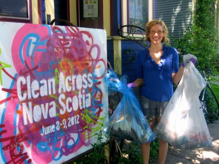Volunteer Kiki Woods poses in front of one of the Clean Across Nova Scotia bases on Robie Street (photo Natascia Lypny).