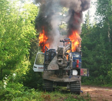 Shot-hole driller ablaze down the Bass River road. [Photo: Miles Howe]