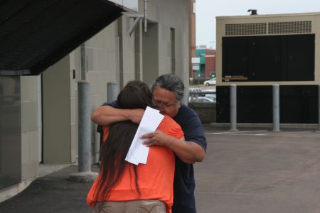 Levi and his soon-to-be wife share a hug upon his release. [Photo: Miles Howe]