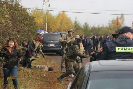 Elsipogtog youth runs in fear as RCMP descend into madness. [Photo: Miles Howe]