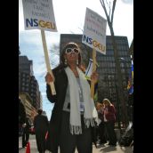 Protester proves picketing can be glamorous as she holds 2 NSGEU placards