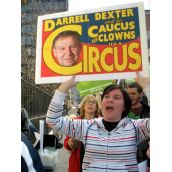 King's student Lisa Todd holds a poster saying "Darrell Dexter and his Caucus of Clowns"
