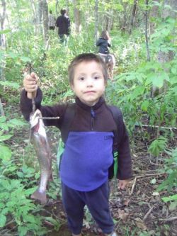 Kaktogowaas, Troy's son, with his trout catch from Skye River, We'koqma'q, Nova Scotia