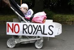 Reality check: A baby stroller adorned with signs of protest against the upcoming visit of the Queen of England was pushed through St Stephen's Green in Dublin May 16, 2011