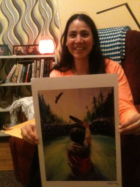 Annie holding Fanny Aishaa's take on the iconic picture taken by APTN's Ossie Michelin. It will be available at Sunday's silent auction. Photo facebook