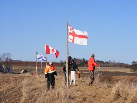 Opponents of the Alton Gas project raising Mi'Kmaq and Canadian flags at the site. The company has since surrounded the flags with a fence.