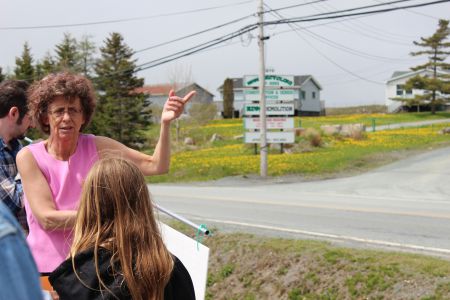 Marlene Brown, a Harrietsfield resident of over 30 years, stands across from RDM Recycling and educates community members about the pollution from the site, how to test their wells and where to get safe water from. [Photo: R. Hussman]