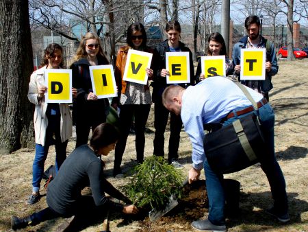 Divest Dalhousie members gather together to plant a tree, during the President's Advisory Council of Sustainability meeting, April 22nd. [Photo: Kendra Lovegrove] 