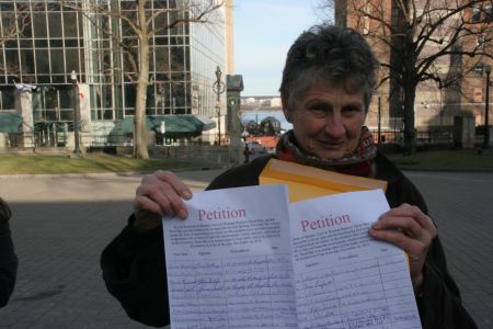 Marike Findley, president of APES, with petition. [Photo: Miles Howe]