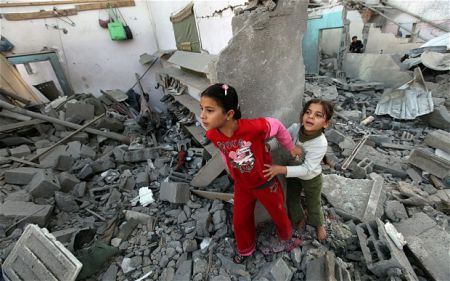 Two children in Gaza house ruins.  Photo by the Telegraph, London.