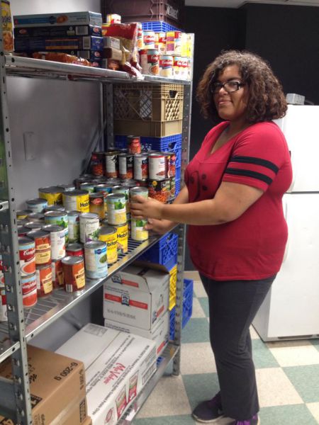 Volunteer Kehisha Wilmot stocking the MSVU Wellness Pantry for incoming students [photo: J. Grant]