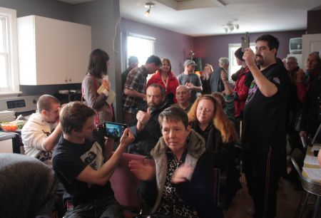 About 25 people crammed into the tiny room to hear the press conference. (Photo by Hilary Beaumont.)