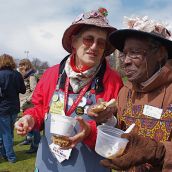 Norma Scott and Ina Kelson of Halifax's Raging Grannies eat free locally produced veggies to protest corporate control of food. 