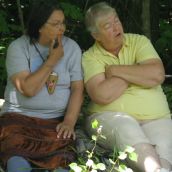 Alma Brooks of St. Mary's First Nation and Vicki Oland of Durham Bridge chat at the blockade of seismic vibrators in Stanley, NB. Photo: Tracy Glynn. 