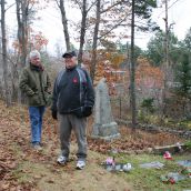 Dan and Steven Jollimore at the family plot in the cemetery that they believe got damaged during road construction.  Photo Robert Devet
