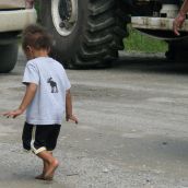A child walks past the seismic truck blockade in Stanley, NB on August 9, 2011. Photo: Tracy Glynn.