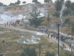 Demonstrators at the weekly non-violent protest in Bil'in village are met with volleys of tear gas launched by Israeli Defence Forces. Despite IDF regulations, soldiers shoot high velocity tear gas canisters directly at protesters, causing an Israeli protester to suffer a fractured skull and internal bleeding on April 23, 2010.