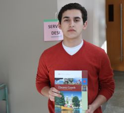 Yazan Khader, a 'New Canadian' citizen originally from Palestine, holds a copy of 'Discover Canada', the study guide from which the department of Citizenship and Immigration will determine if you 'know' what it is to be Canadian. [Photo: Miles Howe]