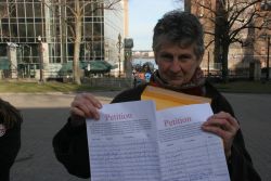 Marike Finlay Holds Petition Against Open Pen Salmon Farming on the Eastern Shore. [Photo: Miles Howe]