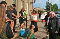 Earlier in the summer, AFN Regional Chief Roger Augustine confronted First Nations women handcuffed outside his yearly 'Fishermens' Pow Wow' [Photo: Miles Howe]