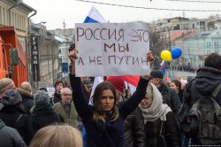 The placard held by this Russian woman participating in a peace march in Moscow, says "We are Russia - not Putin."